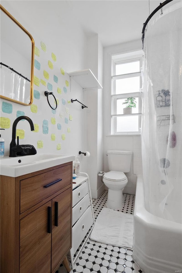 full bathroom featuring vanity, toilet, and shower / bathtub combination with curtain