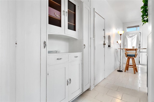 hallway featuring light tile patterned floors