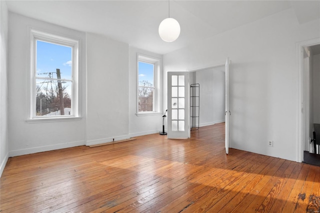 empty room featuring light wood-type flooring and a wealth of natural light