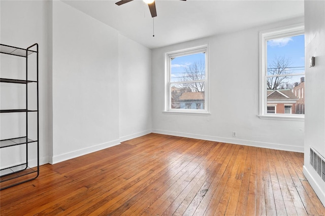 spare room with hardwood / wood-style flooring and ceiling fan