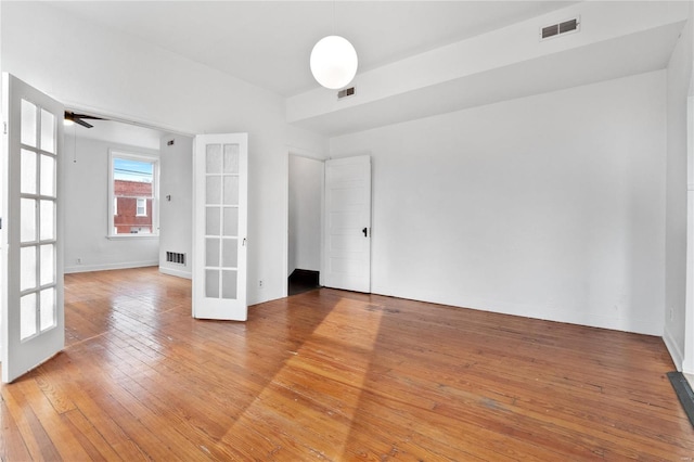 unfurnished room with french doors, ceiling fan, and hardwood / wood-style floors