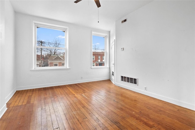 spare room featuring hardwood / wood-style floors and ceiling fan