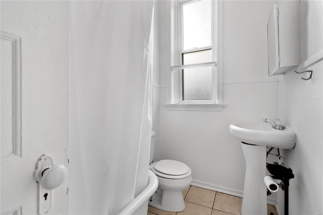 bathroom with tile patterned flooring and toilet