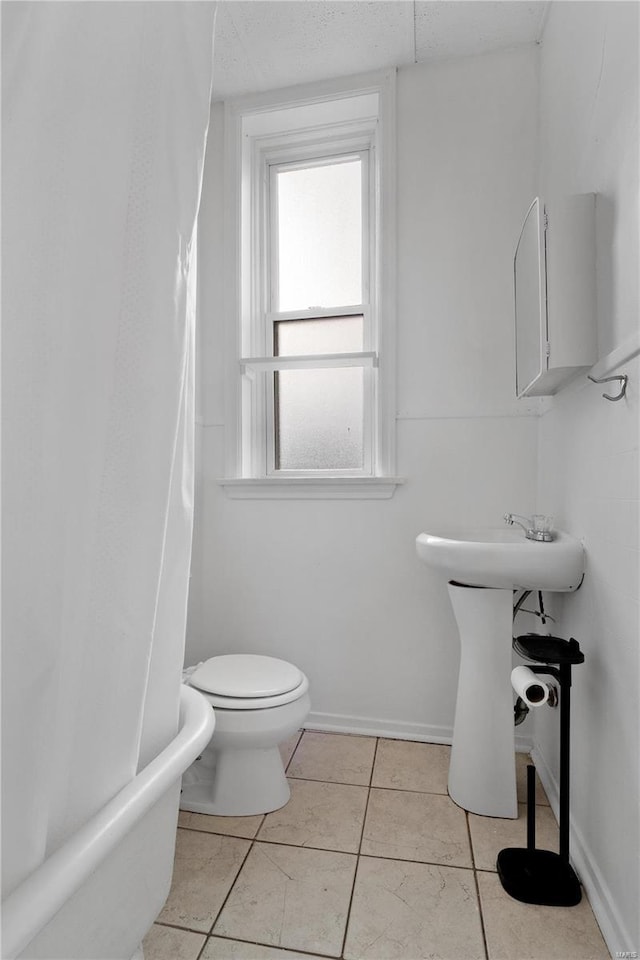 bathroom featuring tile patterned floors and toilet