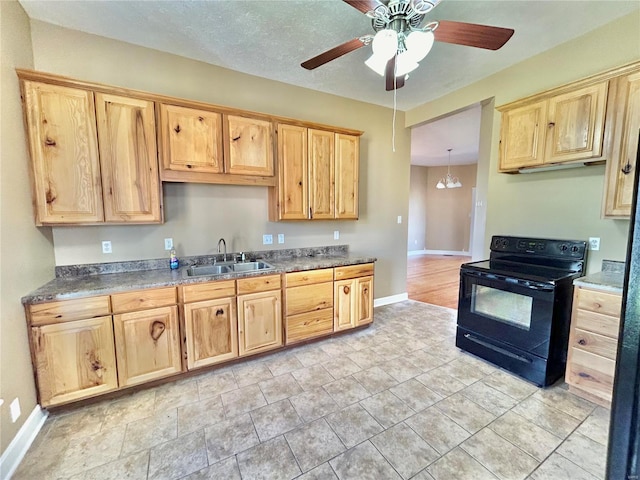 kitchen with sink, black electric range, pendant lighting, light tile patterned flooring, and ceiling fan with notable chandelier