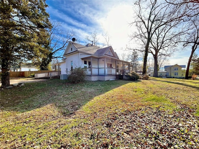 view of side of home with a yard