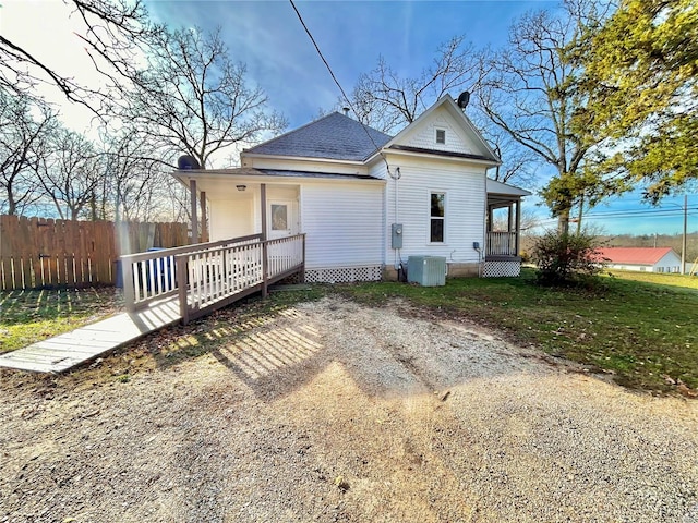 rear view of house featuring a wooden deck and central air condition unit