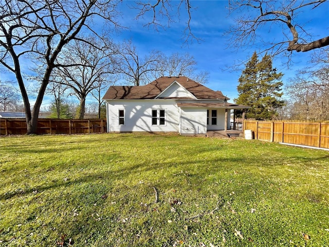 rear view of house featuring a lawn