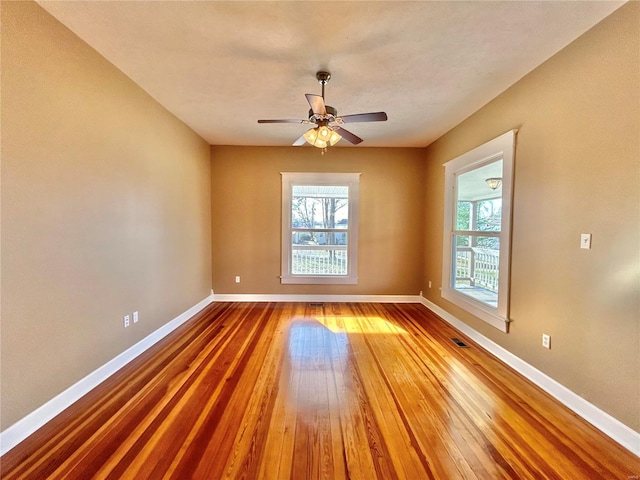 spare room featuring hardwood / wood-style floors and ceiling fan