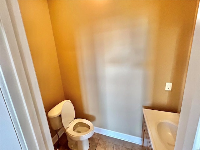 bathroom with tile patterned flooring, vanity, and toilet