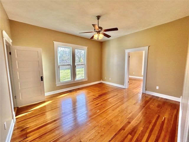 empty room with light wood-type flooring and ceiling fan