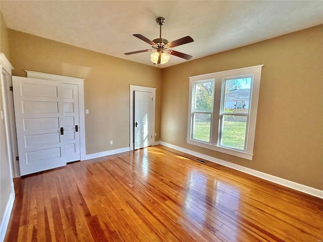 unfurnished bedroom featuring hardwood / wood-style flooring and ceiling fan