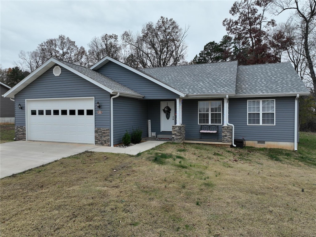 ranch-style home featuring a garage and a front lawn