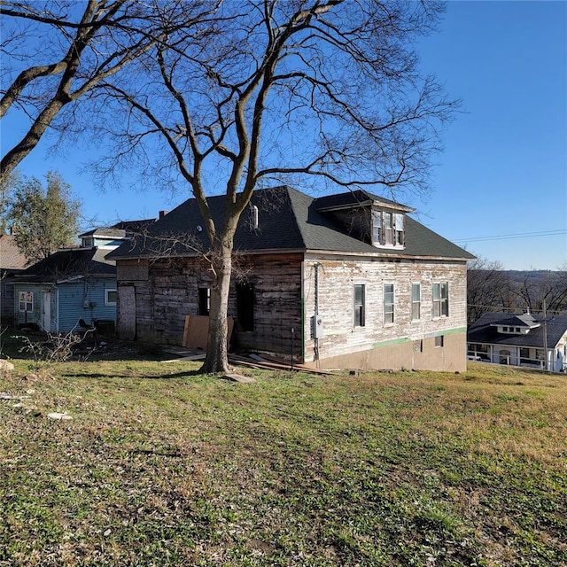 rear view of house with a lawn