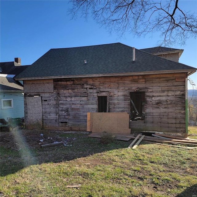 rear view of property with a lawn