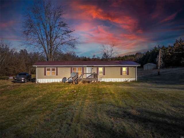 manufactured / mobile home with a yard and a shed