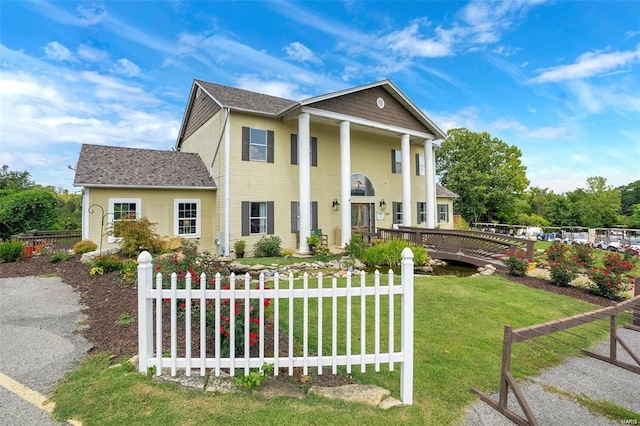 neoclassical home with a front yard