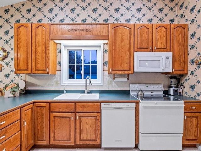 kitchen featuring white appliances and sink