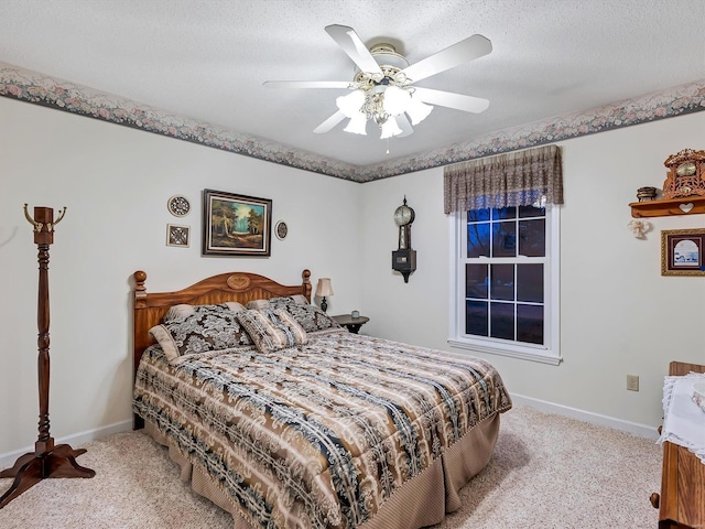 carpeted bedroom featuring a textured ceiling and ceiling fan