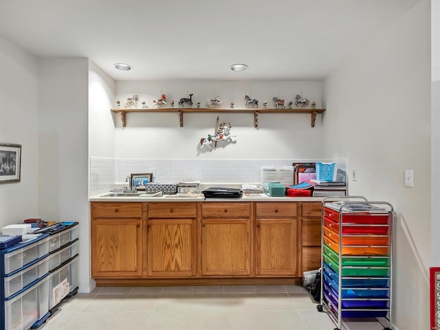 kitchen featuring light tile patterned floors and tasteful backsplash