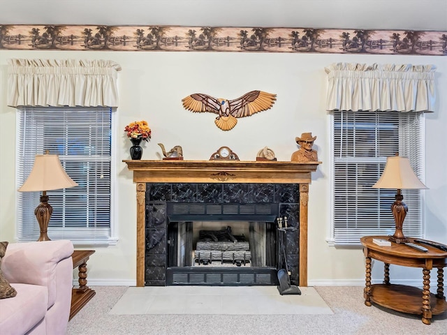 room details featuring a tile fireplace and carpet