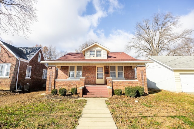 bungalow-style house with covered porch and a front lawn