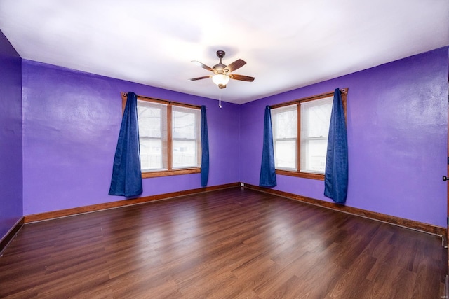 spare room with ceiling fan, dark hardwood / wood-style flooring, and a wealth of natural light