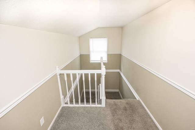 stairs with carpet flooring and lofted ceiling