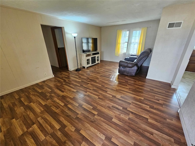 unfurnished living room featuring dark wood-type flooring