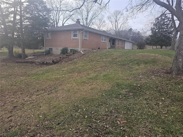 view of side of property with a lawn