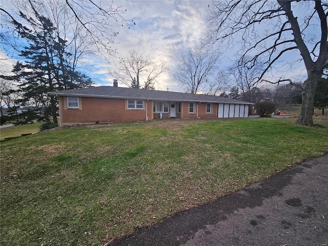 ranch-style home with a lawn and a garage