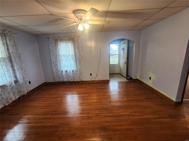 unfurnished room with dark hardwood / wood-style flooring, ceiling fan, and a paneled ceiling