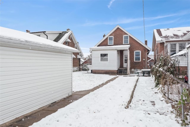 view of snow covered rear of property