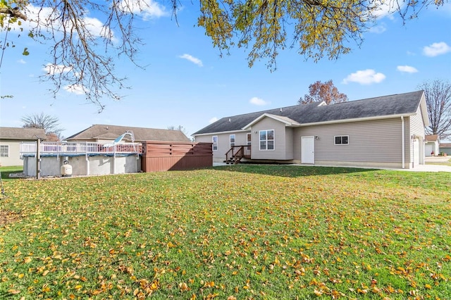 rear view of house featuring a yard