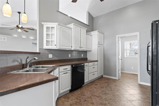 kitchen with decorative backsplash, a towering ceiling, sink, black appliances, and white cabinets