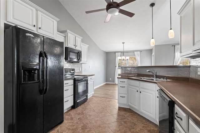 kitchen with backsplash, vaulted ceiling, sink, black appliances, and white cabinets