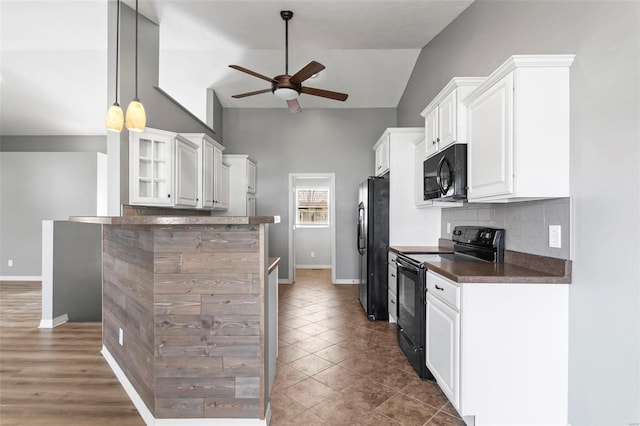 kitchen with black appliances, ceiling fan, white cabinets, and vaulted ceiling