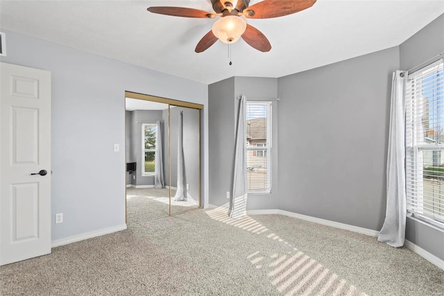 empty room featuring plenty of natural light and light colored carpet