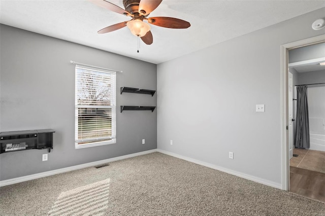 unfurnished room featuring ceiling fan and carpet floors