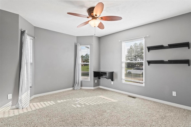 carpeted empty room with ceiling fan