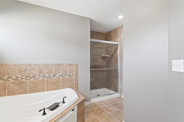 bathroom featuring tile patterned floors and shower with separate bathtub