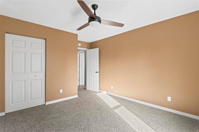 unfurnished bedroom with ceiling fan, carpet floors, and a closet