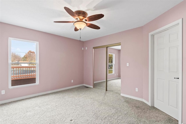 unfurnished bedroom featuring ceiling fan, light colored carpet, and a closet