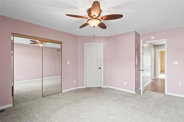 unfurnished bedroom featuring carpet flooring, a closet, and ceiling fan