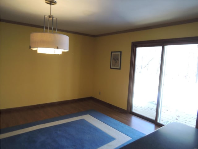 unfurnished room with crown molding and hardwood / wood-style flooring