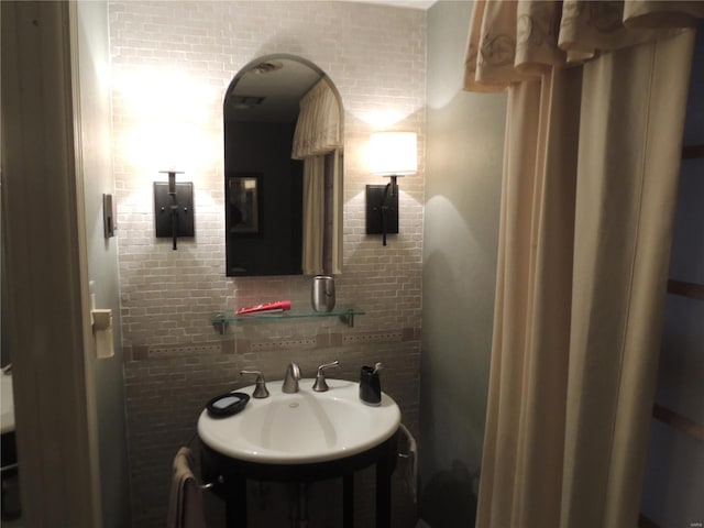 bathroom with sink and decorative backsplash