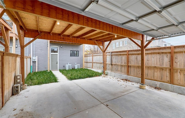 view of patio with a carport and central air condition unit