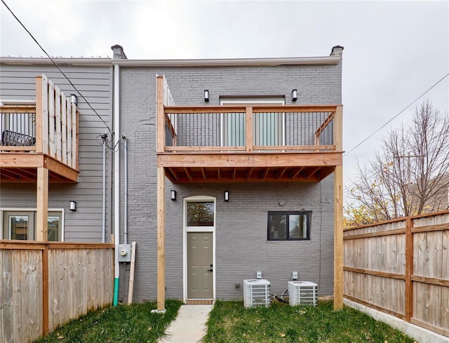 rear view of house with a balcony and central AC unit