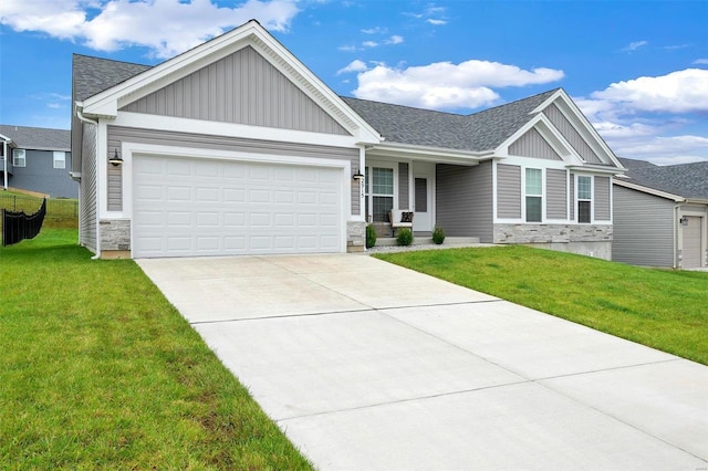 craftsman-style home with a garage and a front lawn