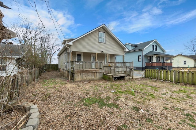 back of property with a porch